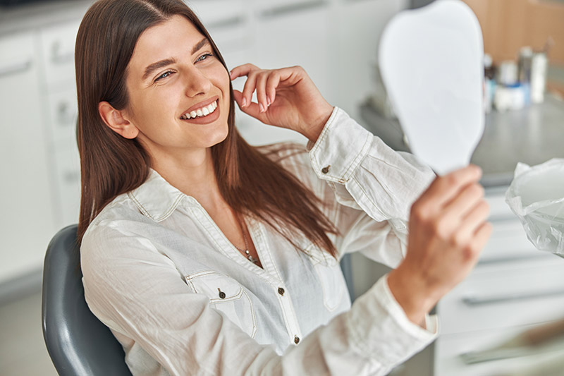 woman loving her cosmetic results from Glendale Dental Associates