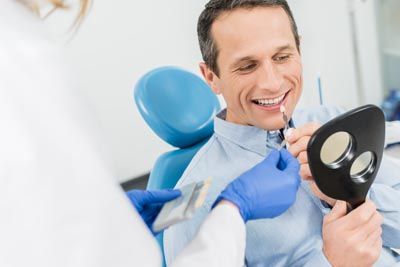 man choosing a dental veneer shade at Glendale Dental Associates